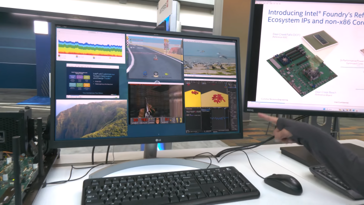Two monitors displaying graphs, software, and games in a tech exhibition setup.