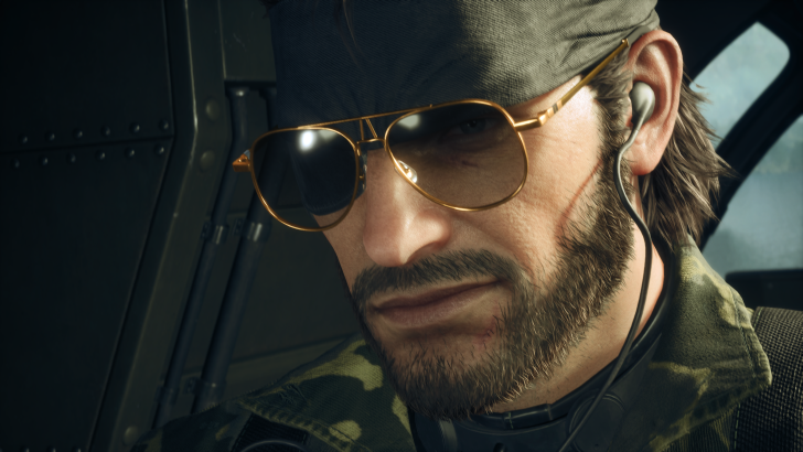 Man wearing sunglasses, headset, and camo in helicopter, looking serious.