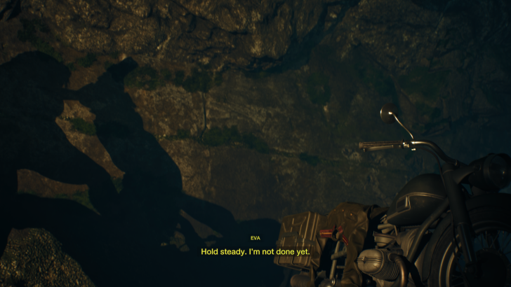 Shadow on rock wall with motorcycle, text overlay: Hold steady. I'm not done yet.