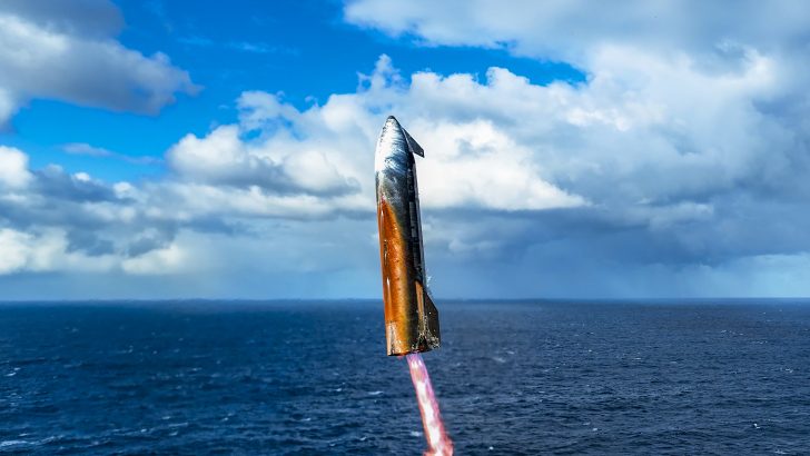 Rocket launching above ocean under cloudy sky.