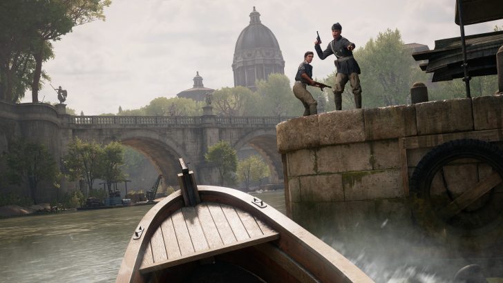 Boat approaches bridge with two people standing on stone ledge, historical architecture in the background.