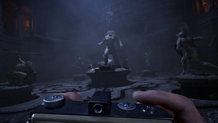 Ancient statues in a dimly lit room, photographed from a first-person perspective.