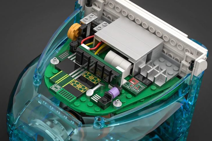 Lego bricks forming a detailed circuit board with wires and components, encased in a translucent blue shell.