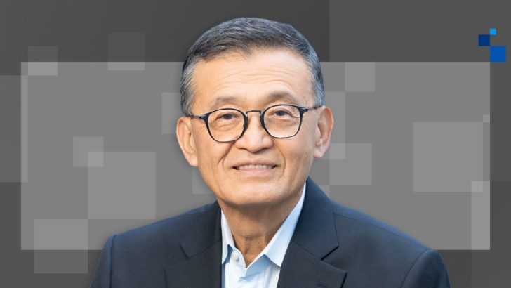 Portrait of a professional man in glasses and a suit with a geometric background.