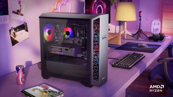 Lenovo desktop with GeForce RTX and AMD Ryzen logo on desk with gaming setup.