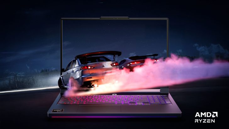 AMD Ryzen logo on a laptop screen displaying a racing game with cars emitting smoke.