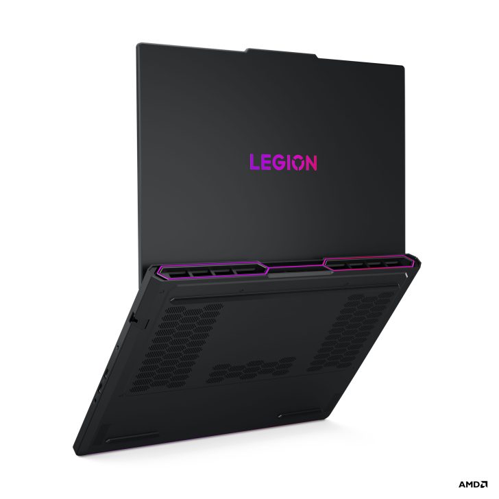 Lenovo Legion laptop with purple logo visible, partially opened showing vent details, and AMD in bottom corner.