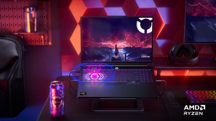 Lenovo Legion laptop with AMD Ryzen 9 and visual effects on keys, surrounded by branded decor and a gaming headset.