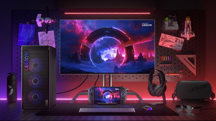 Lenovo Legion gaming setup with desktop, monitor, and controller on a backlit desk against a wall with sketches and models.