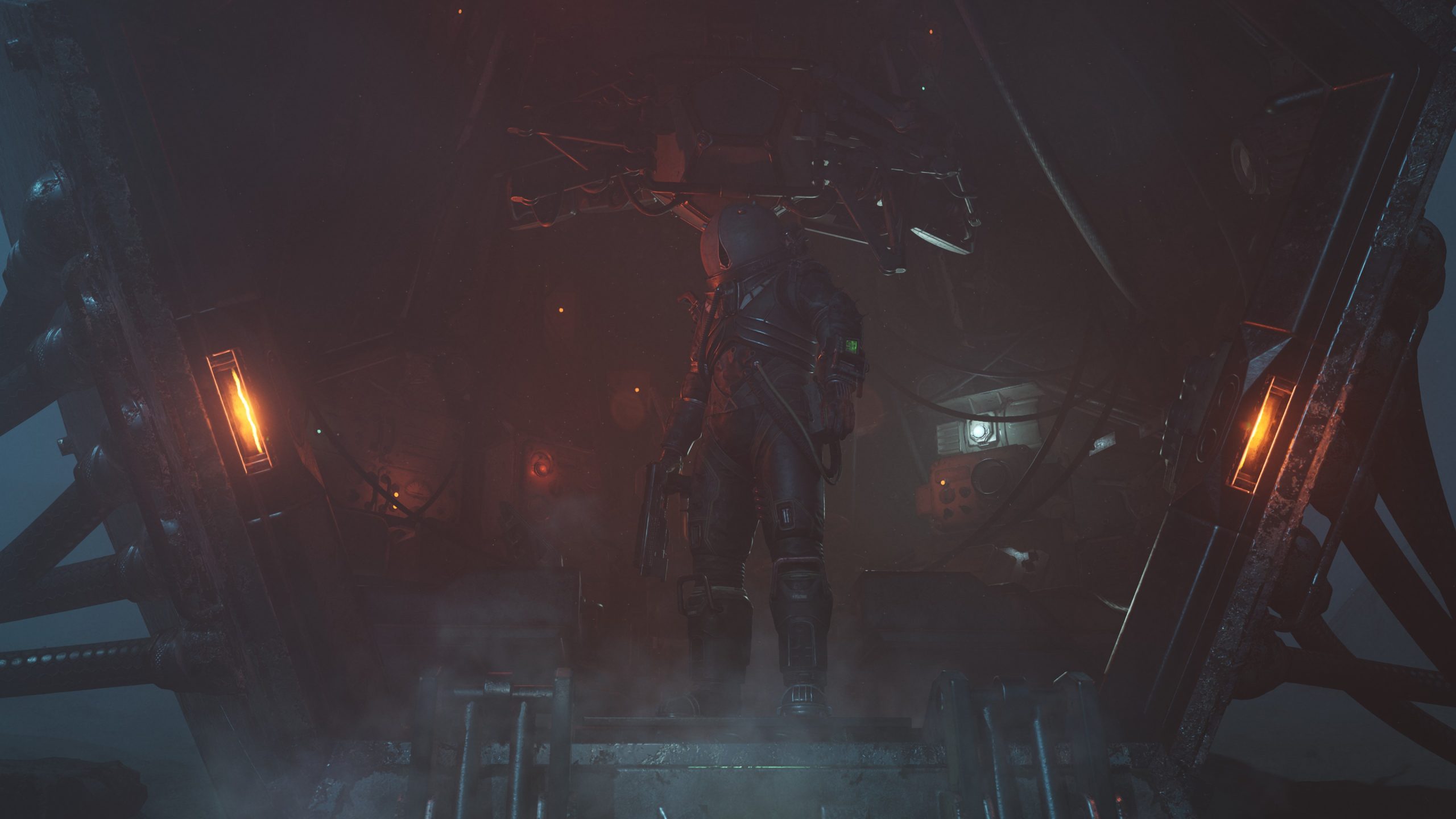 Astronaut in full suit stands at spaceship entrance surrounded by glowing orange and blue lights in dim setting.