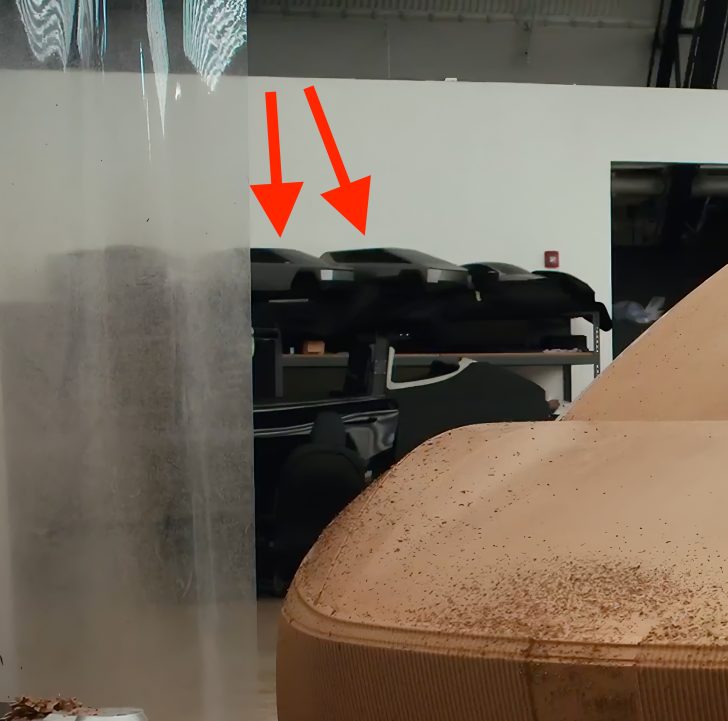 Unbranded car models on shelves in a workshop, with arrows pointing to them.