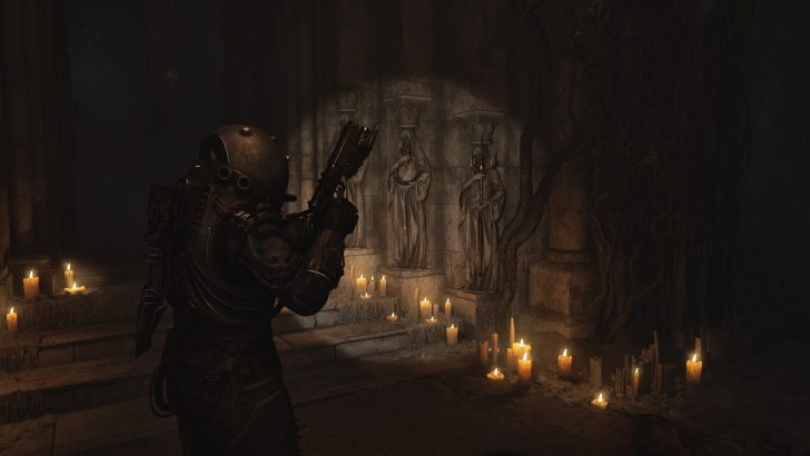 A person in armor holds a weapon in a dimly lit room with candles and statues.