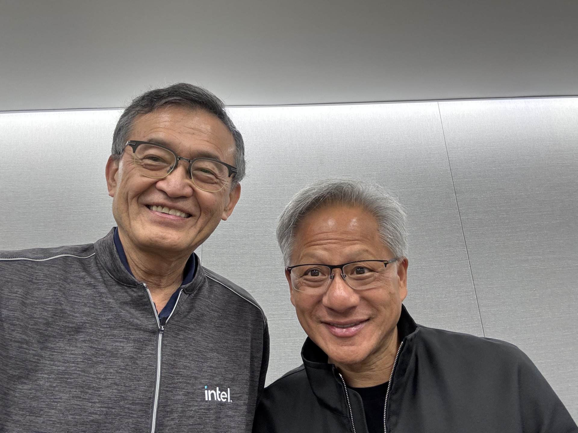 Two men smiling, one wearing an intel logo jacket.