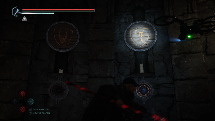 HUD with health bars and R SWITCH WEAPON prompt in a dark stone chamber.