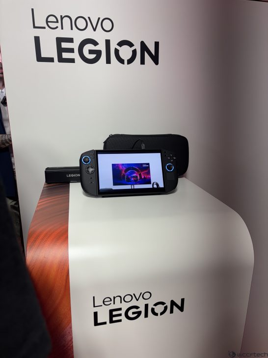 Lenovo Legion handheld gaming console on the display table with Lenovo LEGION text in the background.