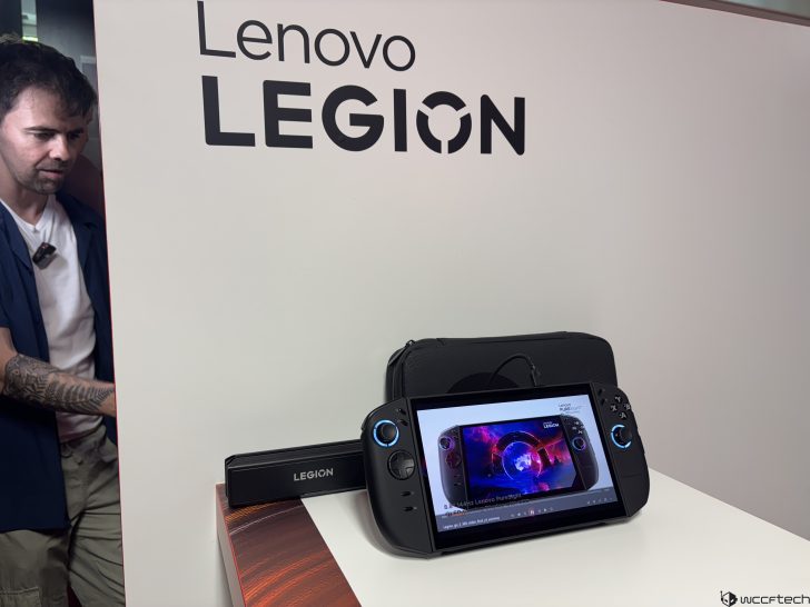 Lenovo Legion gaming device displayed next to a LEGION branded stand, showing a screen with demo content.