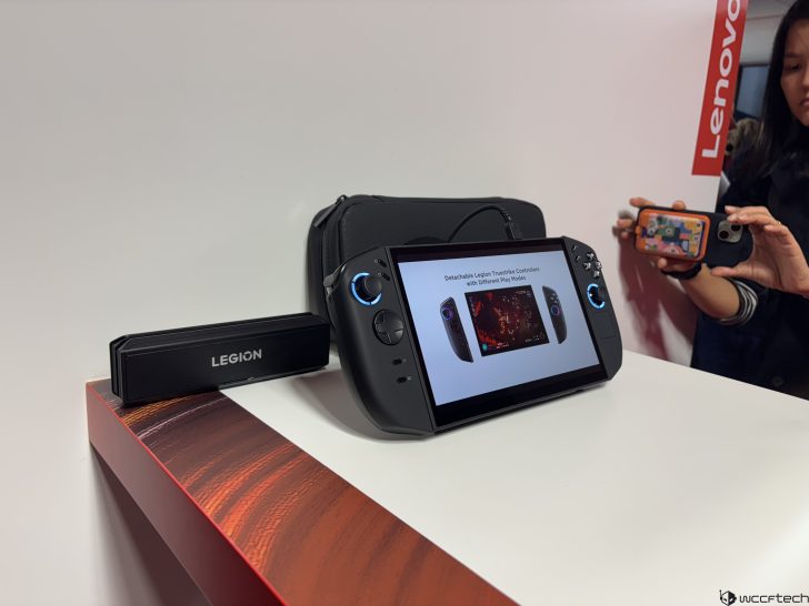 Lenovo Legion portable gaming device with a screen showing Detachable Legion TrueStrike Controllers text, on a display table.