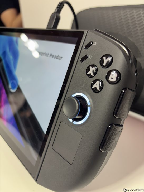 Handheld gaming device with Fingerprint Reader on screen, showing labeled buttons X, Y, A, B, connected via USB.