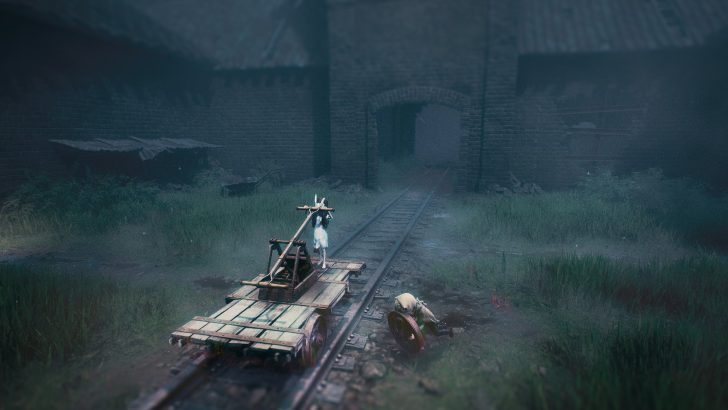 A character on a wooden railcart holds a lever, while another figure with a shield is beside the tracks in a foggy, walled area.