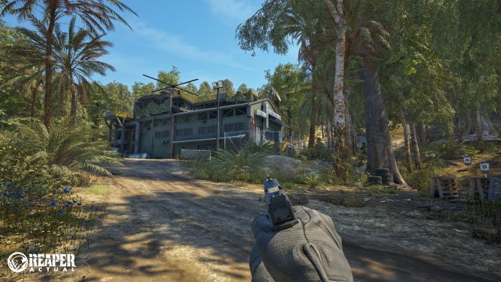REAPER ACTUAL logo on screen by a wooded building with a helicopter on the roof and a person holding a handgun.