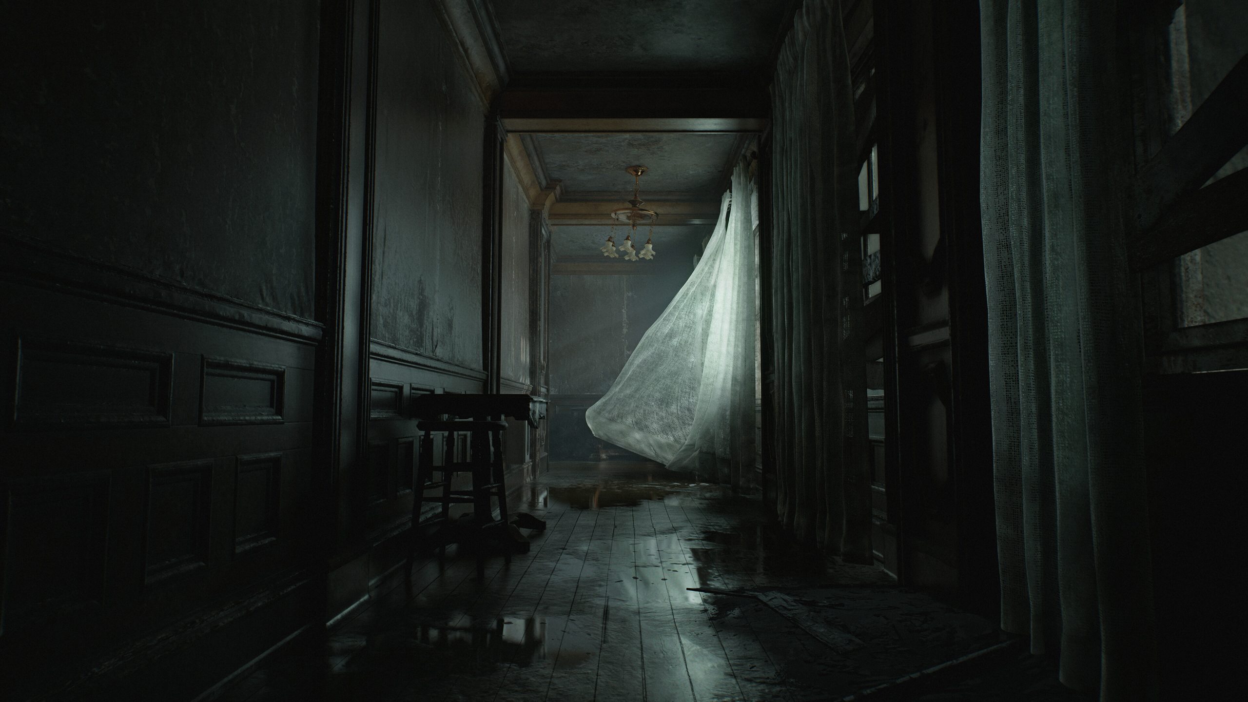 A sheer curtain billows in a dimly lit, abandoned hallway with a wooden floor and water stains.