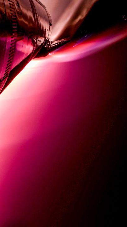 Rocket engine releasing bright red flame during launch.