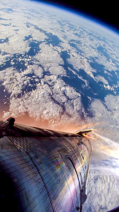 SpaceX Starship descending through Earth's atmosphere with visible re-entry flames.
