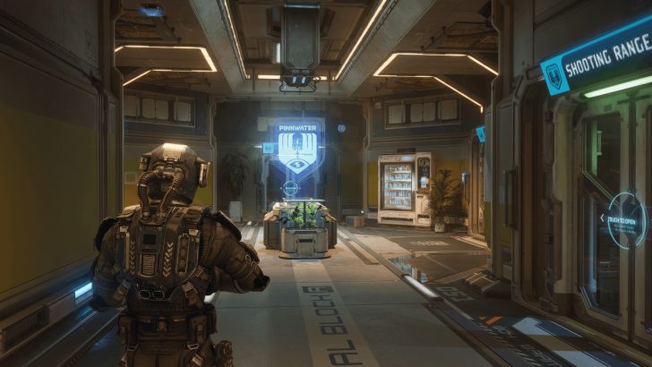 A soldier in armor stands in a futuristic hallway with a PINKWATER hologram and SHOOTING RANGE sign.