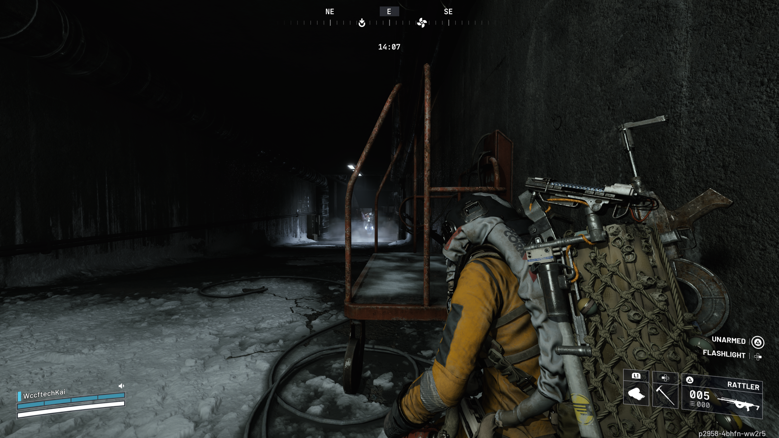 A character in the game 'The First Descendant' is crouching in a dark, snowy corridor, equipped with various gear, including a weapon labeled 'RATTLER,' while an interface shows 'WccftechKai' and 'UNARMED' with 'FLASHLIGHT.'