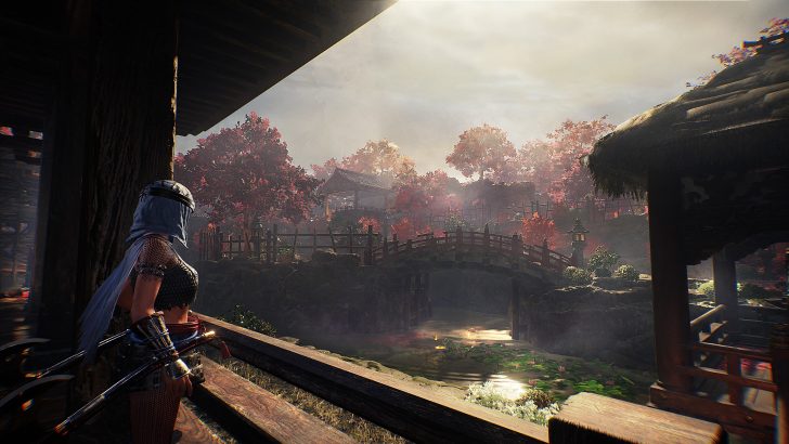 A character with long hair and armor stands in an open-air setting facing a wooden bridge and colorful trees, reminiscent of a historical Japanese village in a video game.