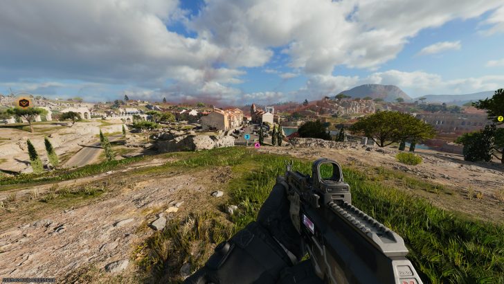 A first-person shooter game scene shows a player holding a rifle while overlooking a detailed landscape of a village with visible markers and pathways.