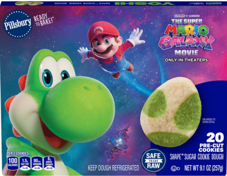 A Pillsbury cookie dough package features Yoshi and Mario from The Super Mario Galaxy Movie with 'Ready to Bake!' and 'The Super Mario Galaxy Movie Only in Theaters' text, alongside a shaped sugar cookie.