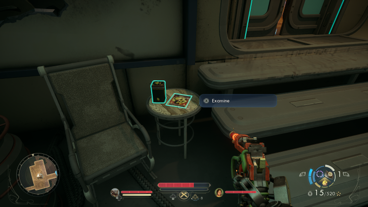 Game screenshot showing “Examine” prompt above a table with a green-lit box and a map, next to a chair.