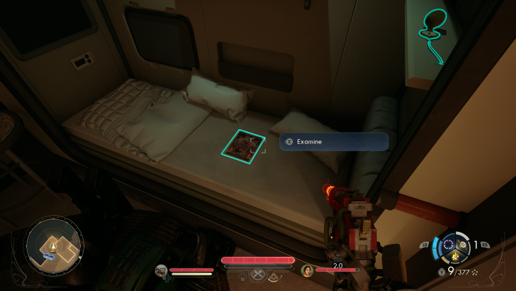A futuristic game interface shows a bed with a prompt to Examine a magazine.