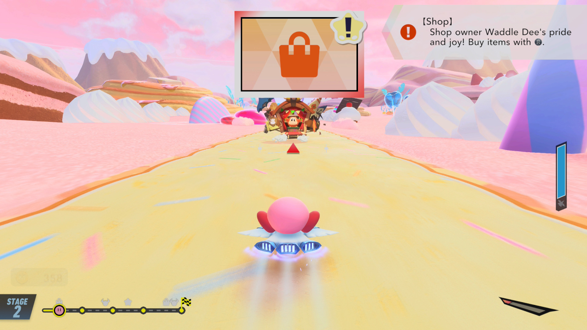 In the game 'Kirby's Dream Buffet,’ Kirby races on a dessert-themed track towards a shopping cart icon with on-screen text saying '[Shop] Shop owner Waddle Dee's pride and joy! Buy items with Ⓡ'.