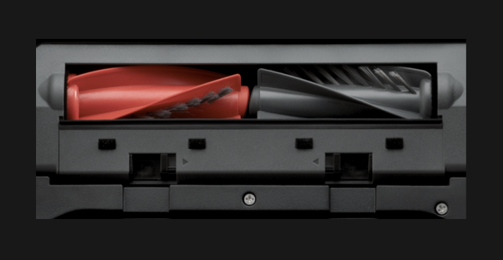 A close-up of an unbranded device showing two rollers, one red and one black, inside a black casing.