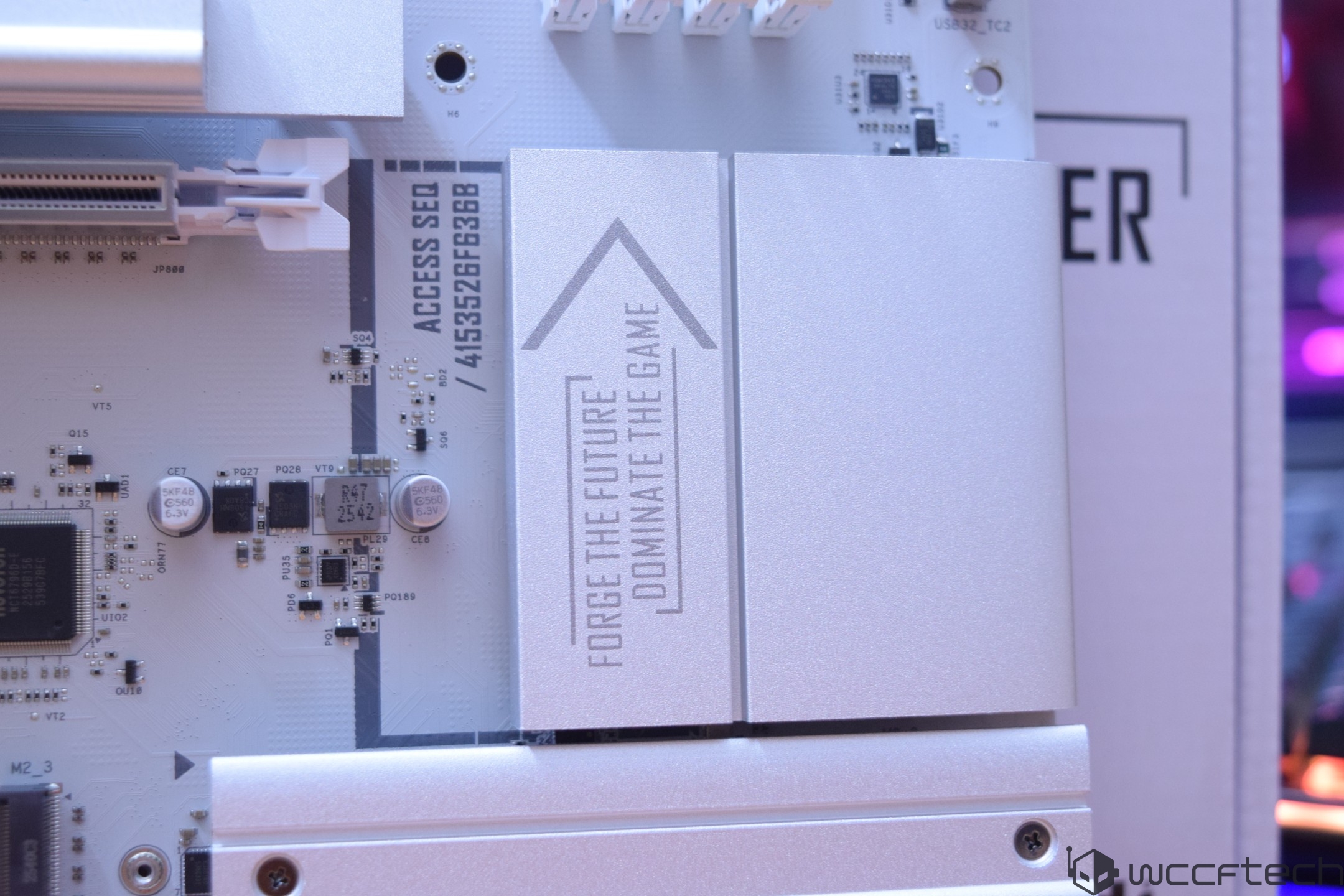 A close-up of a motherboard showing the text 'FORGE THE FUTURE' and 'DOMINATE THE GAME' on a heatsink cover.