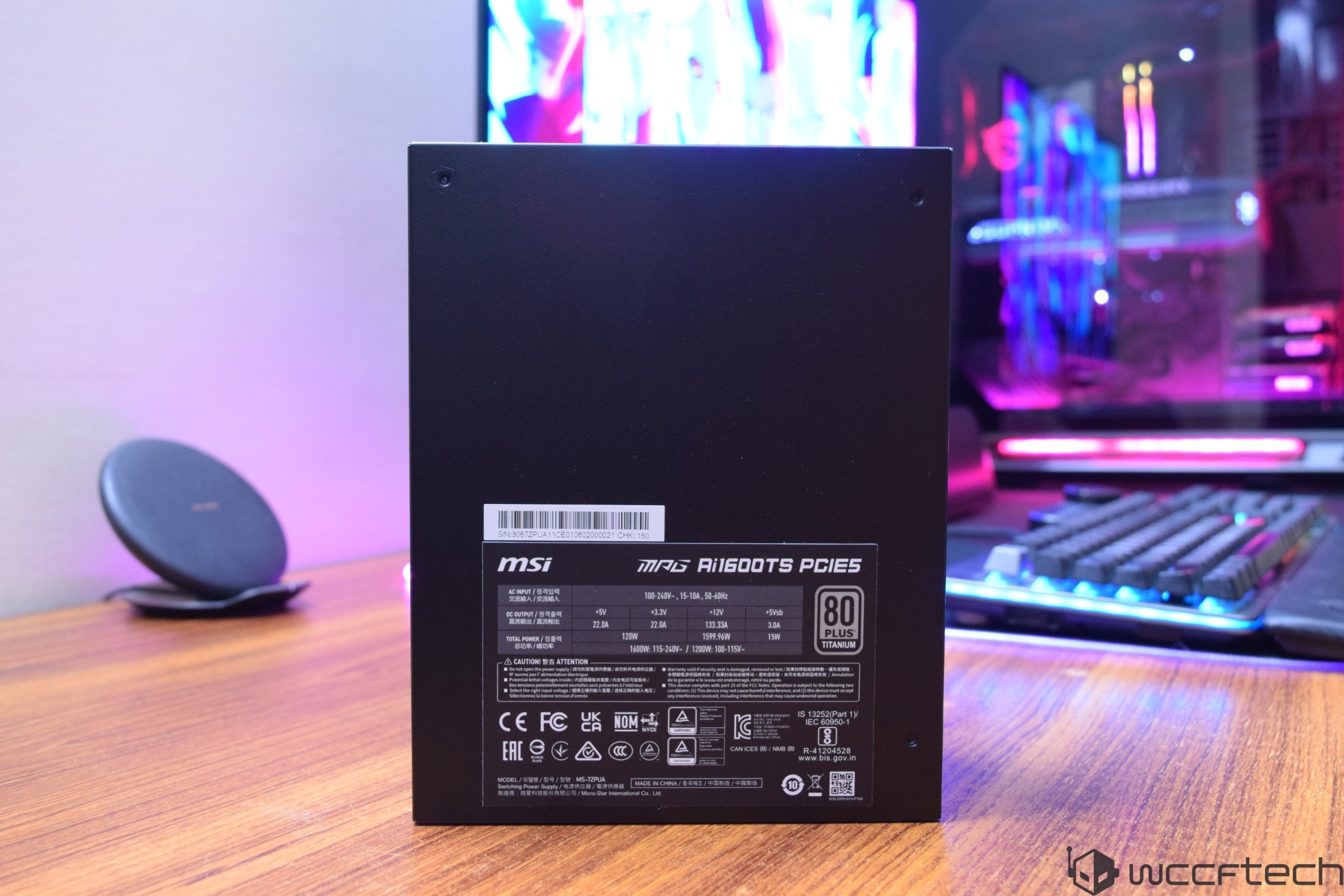The MSI MAG A1600TS PCIE5 power supply unit is shown on a desk with a label featuring '80 PLUS Titanium' certification in a gaming setup.