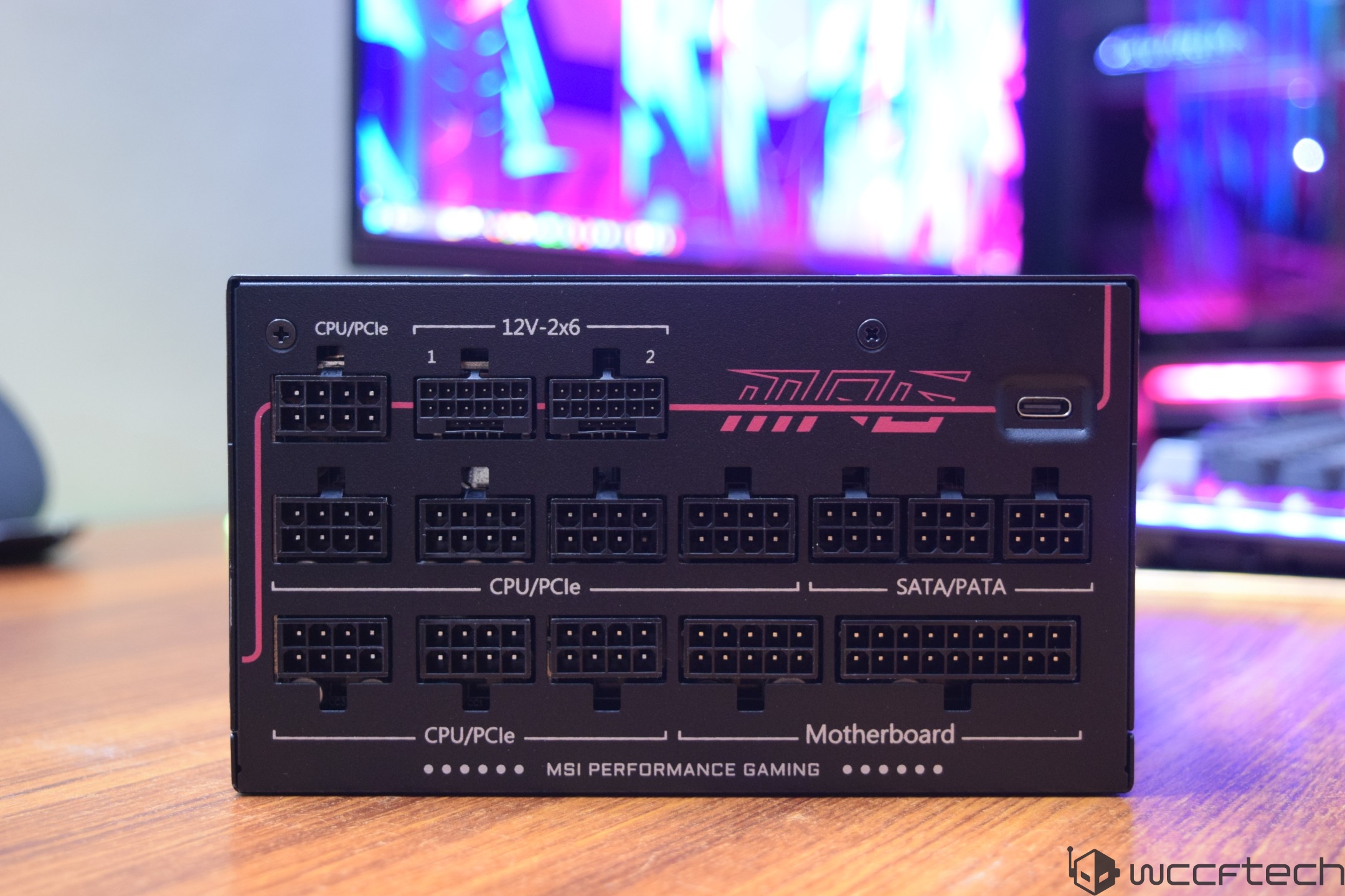 The image shows the back panel of an MSI MPG power supply with multiple labeled ports for 'CPU/PCIe', 'SATA/PATA', and 'Motherboard,' along with branding that reads 'MSI Performance Gaming.'