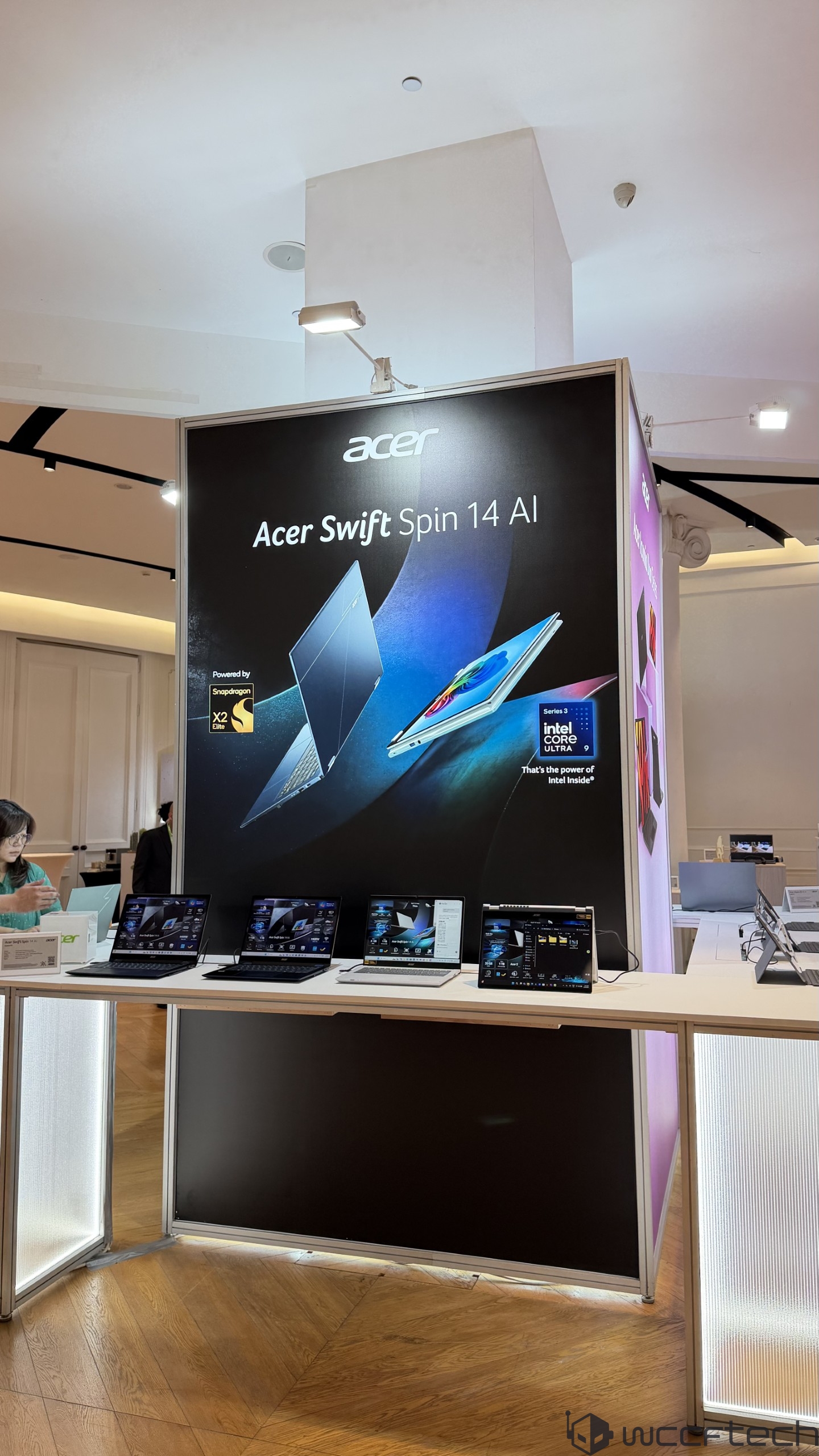 A display booth featuring Acer Swift Spin 14 AI laptops, with branding for Snapdragon X2 Gen and Intel Core Ultra 9.