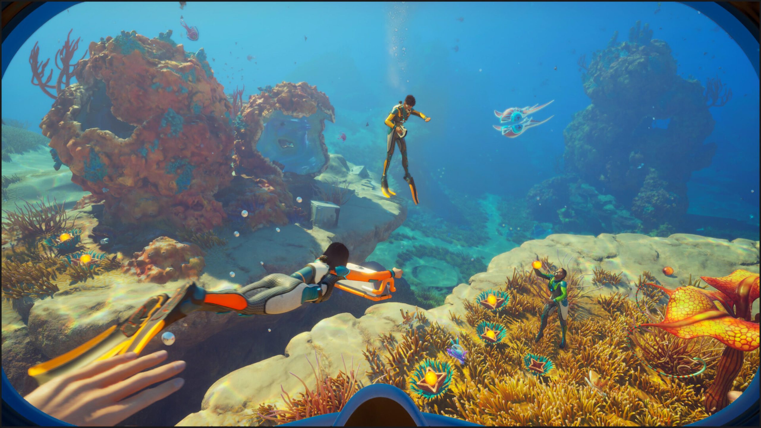 A scene from the game 'Subnautica 2' shows multiple divers exploring an underwater coral landscape.