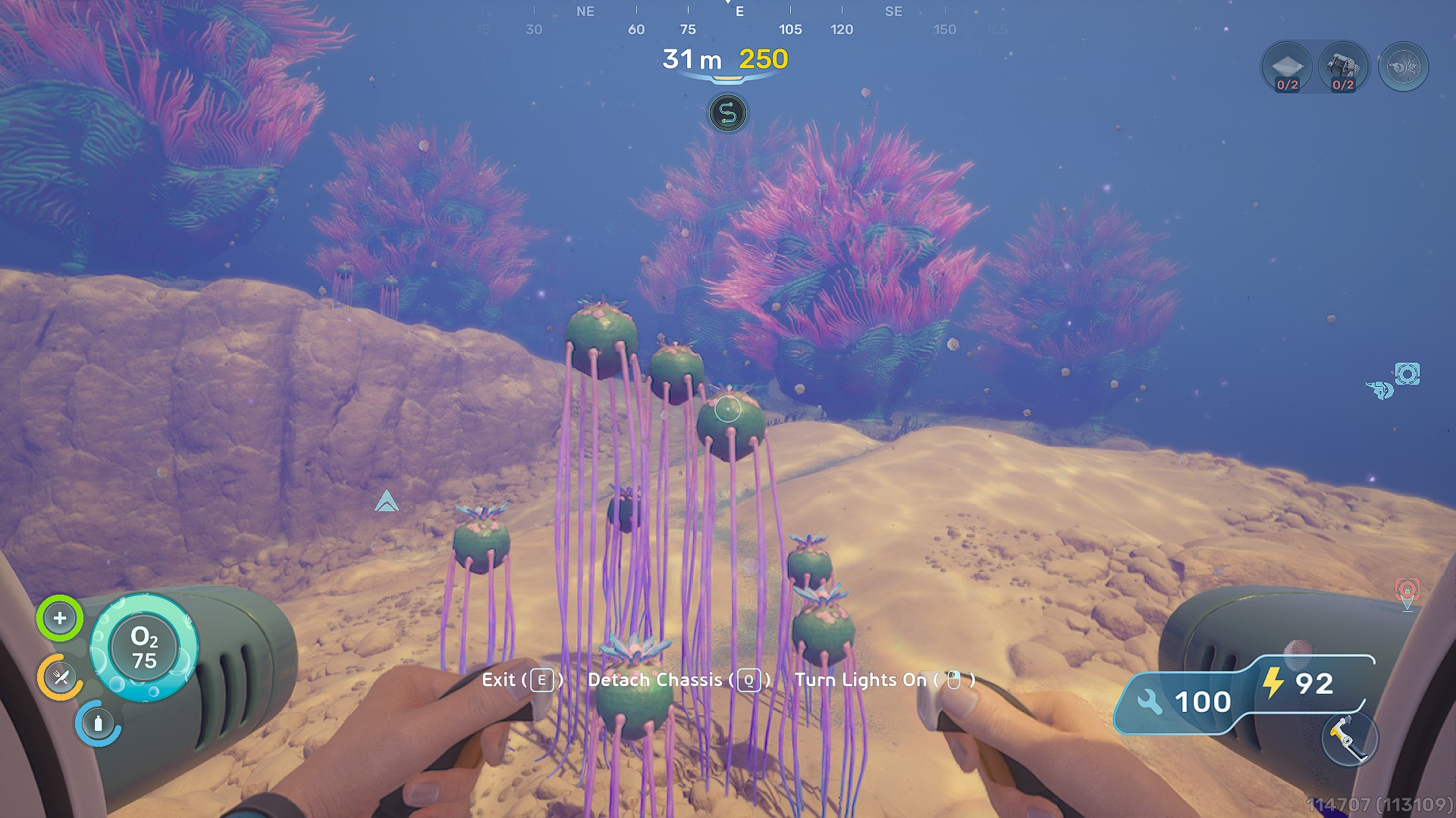 A player in Subnautica pilots an underwater vehicle with a HUD displaying 'Exit (E)' and oxygen levels at 'O2 75' while exploring an ocean floor landscape with colorful coral.