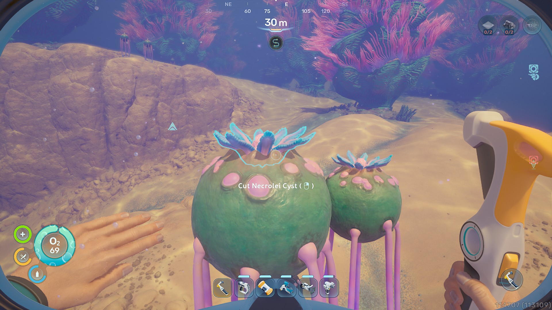 A scene from the game 'Subnautica: Below Zero' shows a player's hand holding a tool, with the on-screen prompt 'Cut Necrolei Cyst' underwater at a depth of 30 meters.