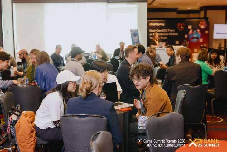 Attendees engage in discussions at the XP Game Summit Toronto 2026, with a visible sign reading 'FastSpring.'