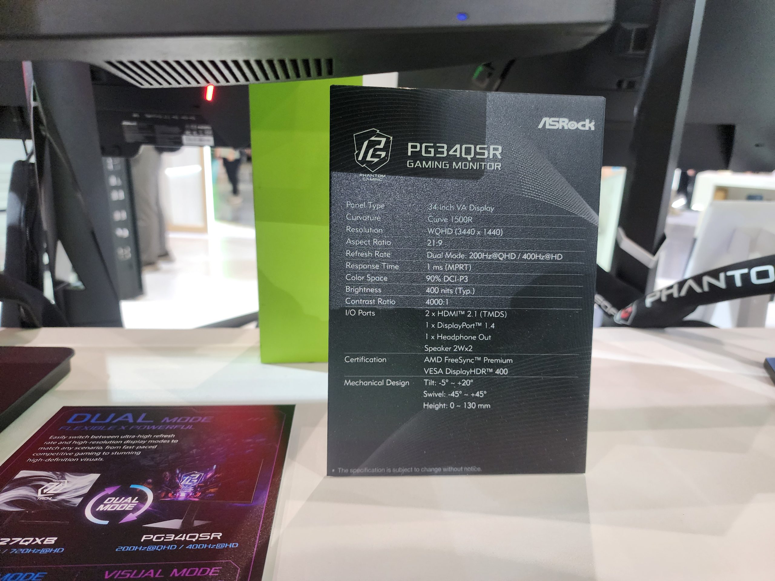 An ASRock PG34Q5R gaming monitor specification sheet details a 34-inch VA display, 1500R curvature, WQHD resolution (3440 x 1440), 21:9 aspect ratio, and a dual mode of 200Hz @ QHD/400Hz @ eHD with 1ms (MPRT) response time.