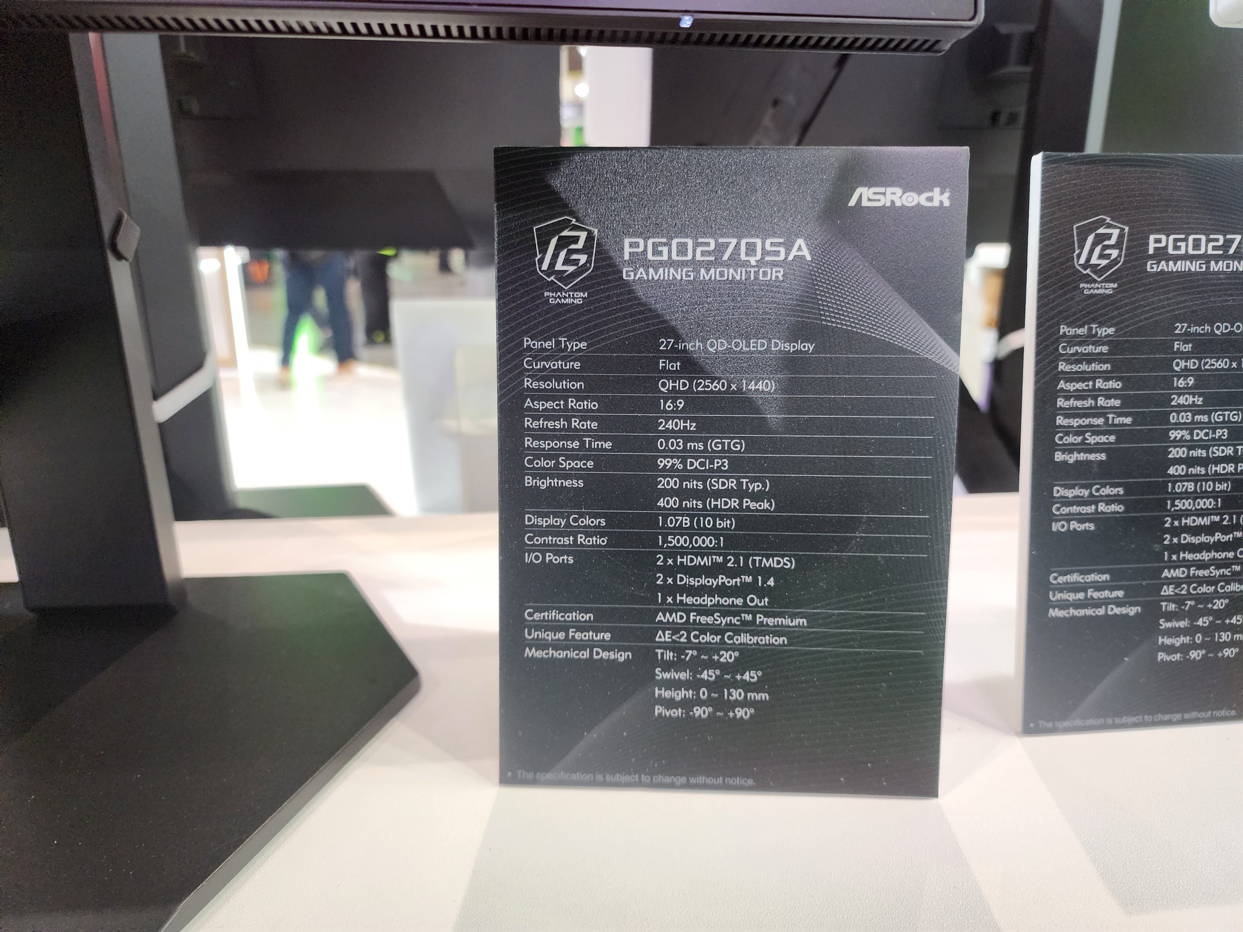 An ASRock PG027Q5A gaming monitor specification card details a 27-inch QD-OLED display, 240Hz refresh rate, 0.03ms response time, and 'AMD FreeSync Premium'.