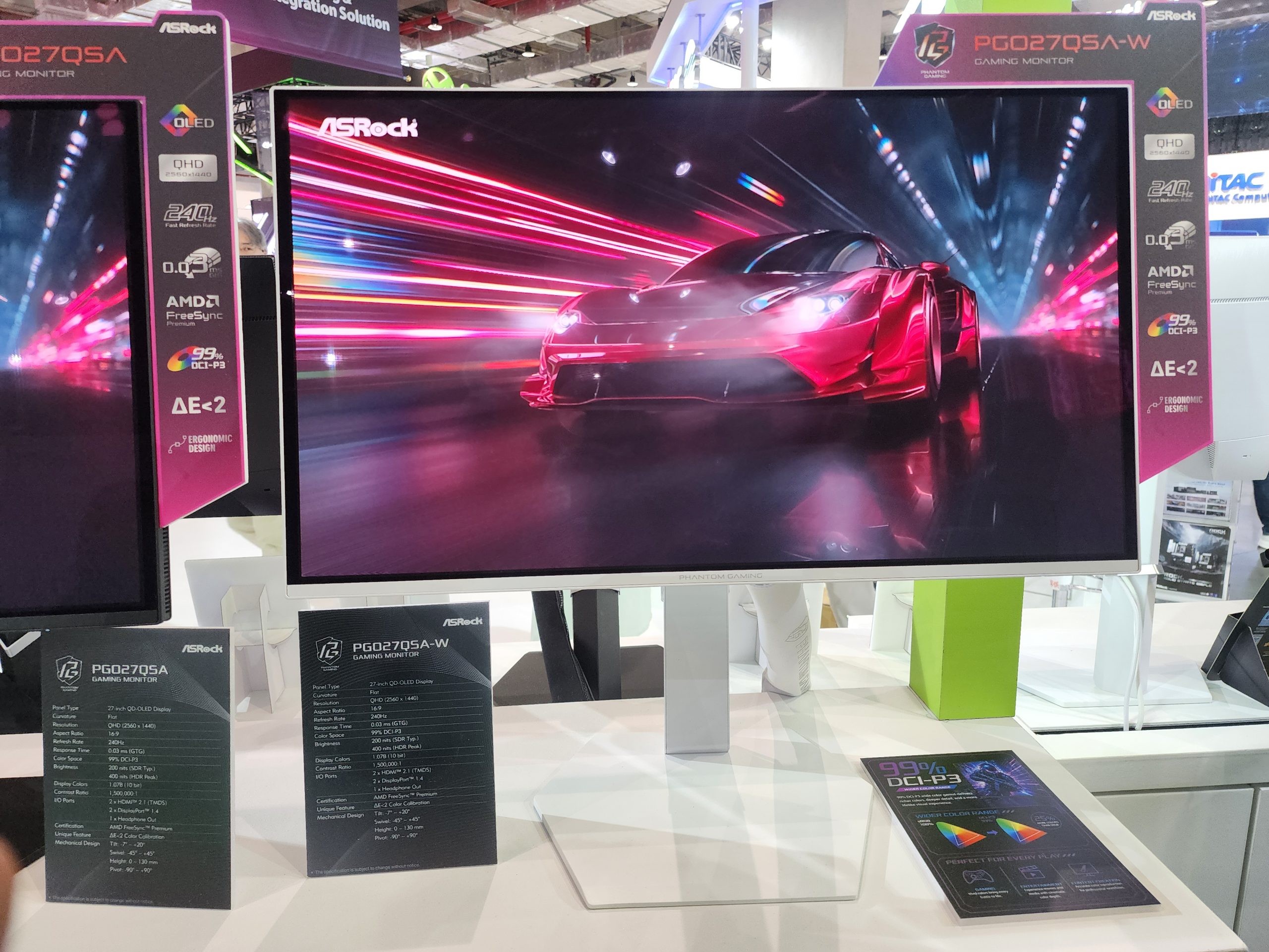 ASRock PGQ270QA-W gaming monitor displaying a red sports car on a colorful racing track, with features listed including 'QHD,' '240Hz,' '0.03ms,' '99% DCI-P3,' 'ΔE<2,' and 'AMD FreeSync.'