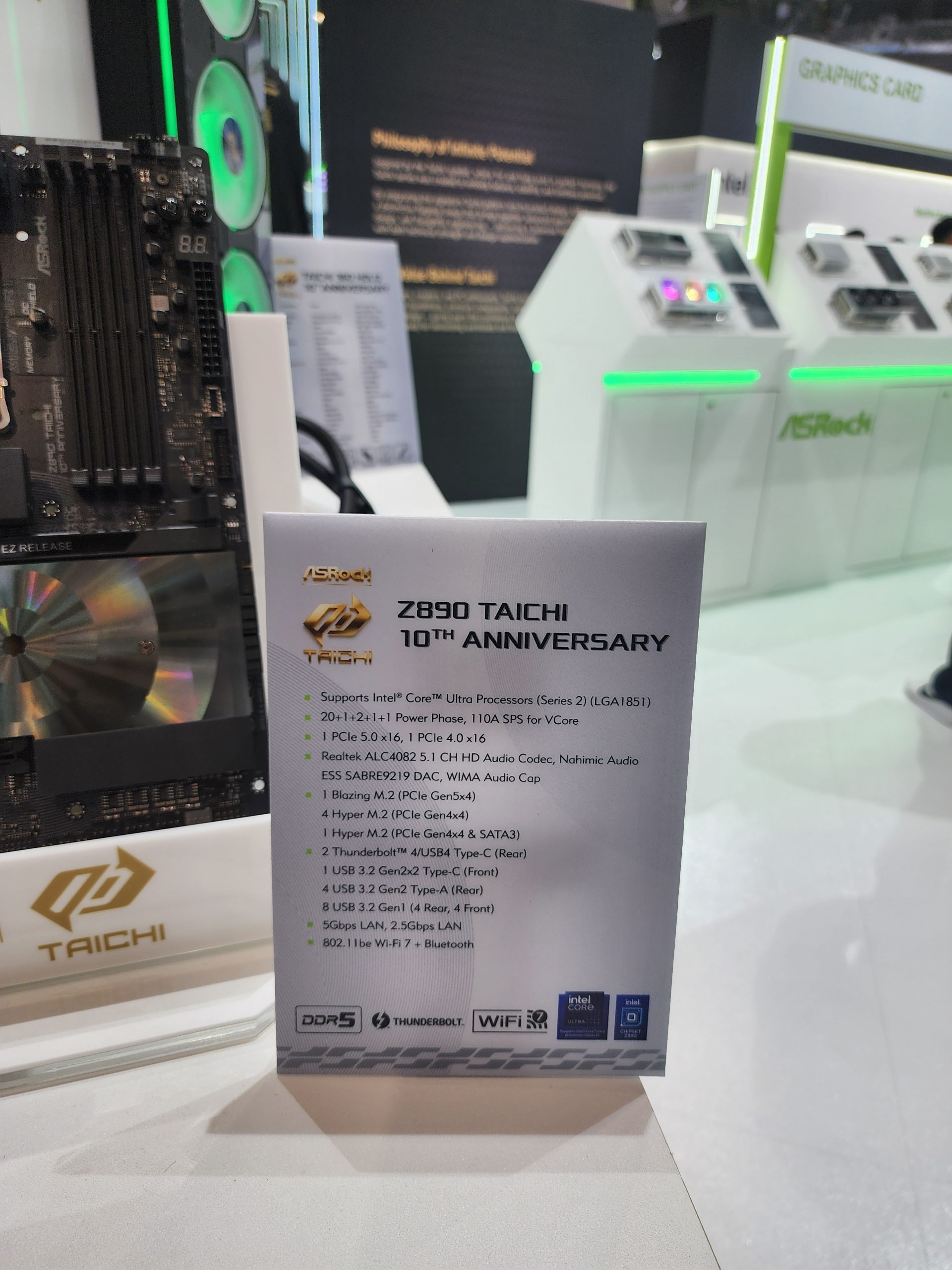 An ASRock display showcases the Z890 Taichi 10th Anniversary motherboard, highlighting features such as support for Intel Core Ultra Processors, DDR5, Thunderbolt 4, and WiFi 7.