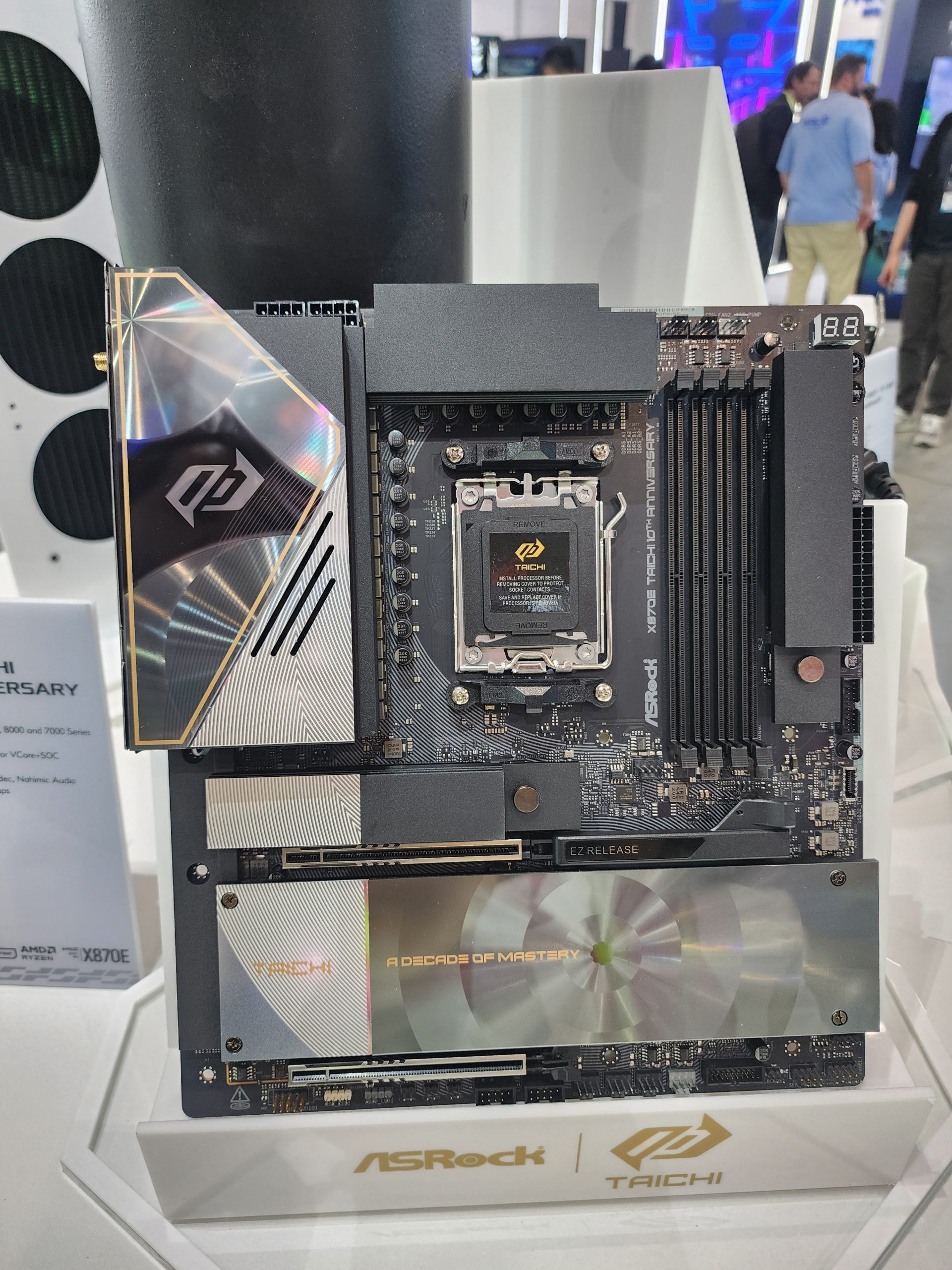 An ASRock Taichi X670E motherboard is displayed with text 'A Decade of Mastery' on the heatsink cover.