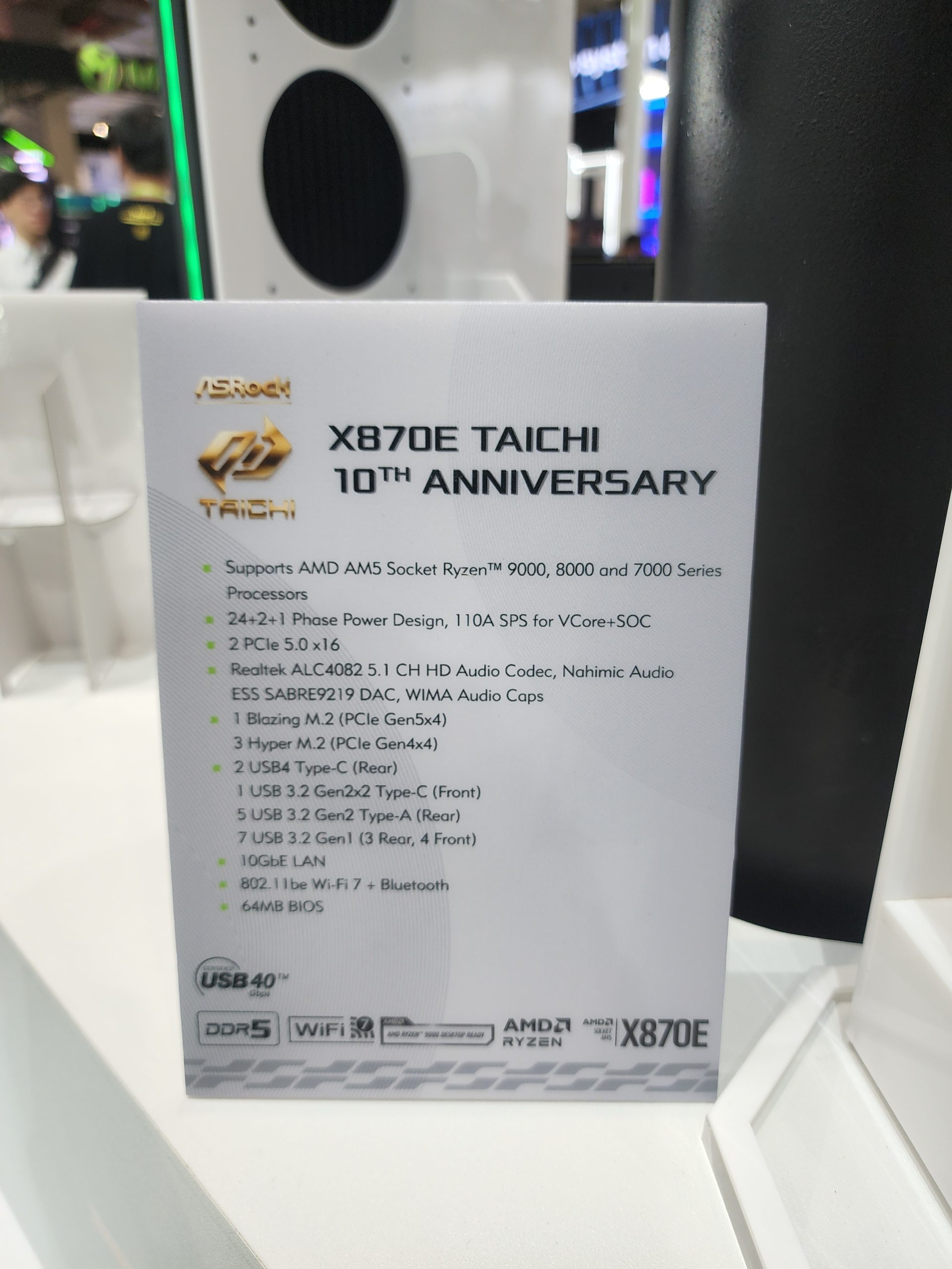 An information card for the ASRock X870E Taichi 10th Anniversary motherboard details support for AMD AM5 Socket Ryzen 9000, 8000, and 7000 series processors, 24+2+1 phase power design, and features like PCIe 5.0 x16, USB4 Type-C, 10GbE LAN, and 802.11be Wi-Fi 7.